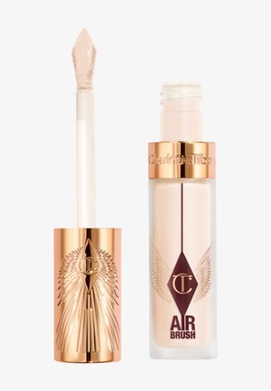 Liquid concealer in a clear tube with gold accents, featuring a winged design. Includes a doe-foot applicator for precise application.