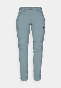 Pantaloni da esterno stretch, di un azzurro chiaro, con tasche con zip e orli regolabili. Il materiale sembra morbido e resistente, progettato per la versatilità.