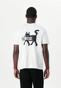 White cotton t-shirt featuring a black graphic of a cat and the text "NOT TODAY" on the back. Short sleeves, relaxed fit.