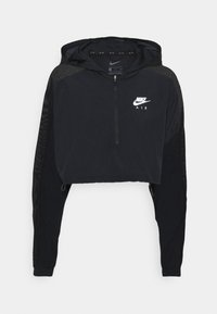 Avskuren svart hoodie i lättviktsmaterial, med en halvdragkedja framtill, mesh-sidor och vit Nike Air-logotyp på bröstet.