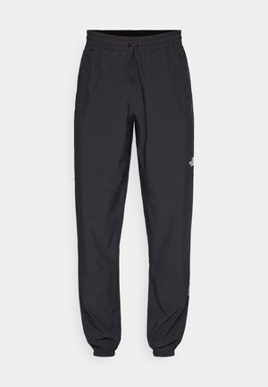 Schwarze Sporthosen aus leichtem Stoff, mit einem Kordelzugbund, seitlichen Taschen und schmal zulaufenden Bündchen an den Knöcheln.