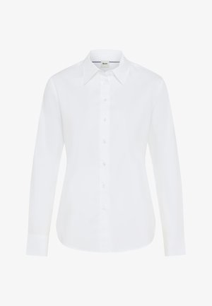 Camicetta bianca a maniche lunghe con bottoni frontali, colletto classico e polsini. Tessuto morbido con una vestibilità su misura e senza motivi visibili.