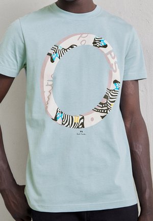 Light blue cotton t-shirt featuring a circular zebra graphic with blue accents, centered text, and a black outline. Classic crew neck design.