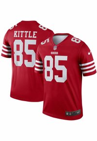 Piros NFL mez fehér kiegészítőkkel. A fronton és a háton "KITTLE" és "85" felirat található, V-nyak kialakítással, valamint csapatlogó jelvény a szegélyen.