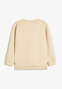 Cremefarvet sweatshirt med ribbet tekstur, rund halsudskæring og lange ærmer. Har elastiske mansjetter og en lige søm.