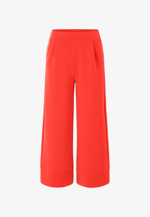 Red, wide-leg culottes with a smooth texture, featuring a high waistband and pleat details, designed for comfort and ease of movement.