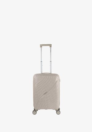Maleta rígida en beige con un diseño texturizado ondulado, asa retráctil y cuatro ruedas de giro suave para una fácil maniobrabilidad.