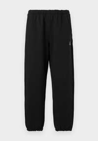 Sorte sweatpants lavet af blødt stof, med elastisk talje, elastiske manchetter og en lille logo-detail på venstre side.