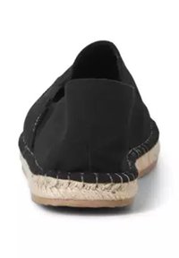 Black espadrille with a soft canvas upper, round cut-out design, and a jute rope sole with stitching details along the edge.