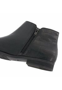 Black ankle boots made of smooth and textured leather, featuring a side zipper and a low, textured heel. Crocodile pattern accents are visible.