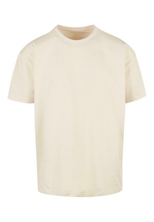 Kreemikas värvi puuvillane T-särk, ümarate kaelustega, lühikeste varrukatega ja lõdva lõikega. Kangas on pehme ja sile, ilma mustrite ja aktsentideta.