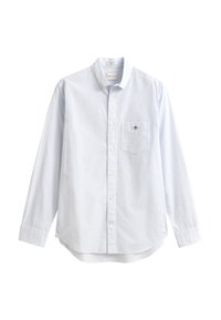 Chemise bleu clair à manches longues en coton avec boutons. Elle comporte une poche sur la poitrine gauche et un col classique avec un petit détail de marque.