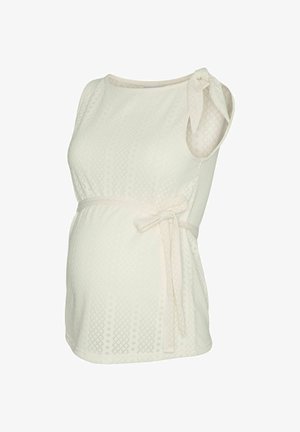 Kreemjas varrukateta raseduspluus tekstuurse rombimustriga, külgedel lipsud vöö all ja üks õlgade juures asuv pael detail.