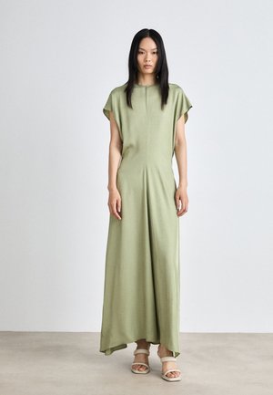 Kergeoliivroheline maxi kleit sujuva tekstuuriga, kapuutsikleebid ja voolav lõige, millele on lisatud minimalistlikud rihmkingad.