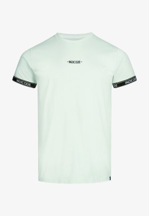Light mint green short-sleeve t-shirt made of cotton, featuring black accents and branding along the sleeves and chest area.