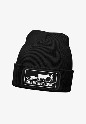 Black knit beanie with a folded cuff, featuring a graphic patch of a man, cow, pig, and chicken, with text “ICH & MEINE FOLLOWER” in white.