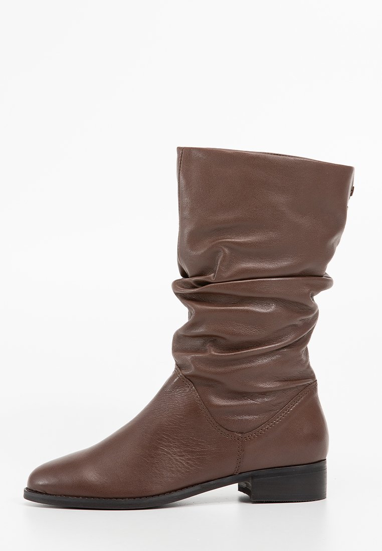 Brown leather ankle boots with a slouchy design, rounded toe, and low block heel. Smooth texture with visible stitching details.