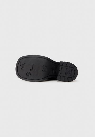 Black rubber shoe sole with textured tread, "MISTA" embossed logo, and a smooth border around the edge. Flat and durable design.