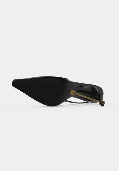 Black pointed-toe high heel shoe shown from the sole, featuring a slim gold metallic stiletto heel against a plain background.
