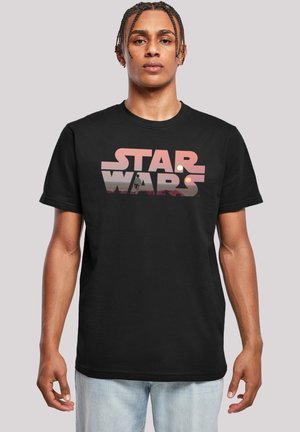 Svart bomullst-skjorte med et flerfarget "STAR WARS" grafikk, med solnedgang og figur i bakgrunnen. Korte ermer og rund hals.