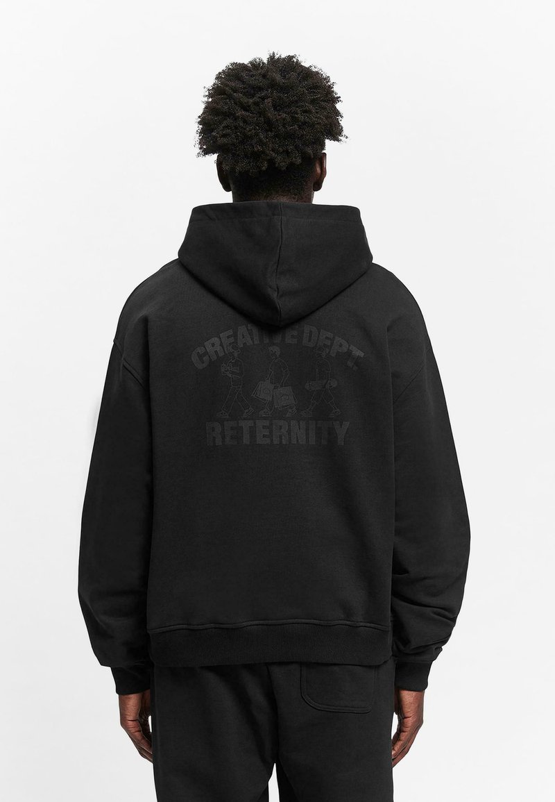 Black hooded sweatshirt made of soft fabric. Features a graphic print on the back with the text “CREATIVE DEPT. ETERNITY.” Loose fit, ribbed cuffs.