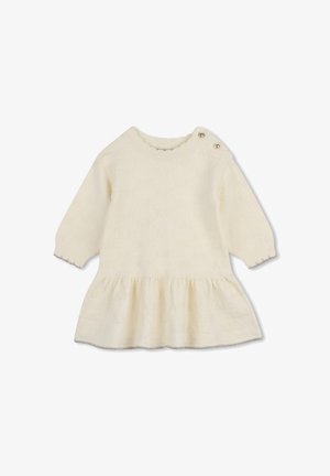 Babyjurk met lange mouwen in crème kleur met geplooide zoom en twee kleine knoopjes op de linkerschouder.