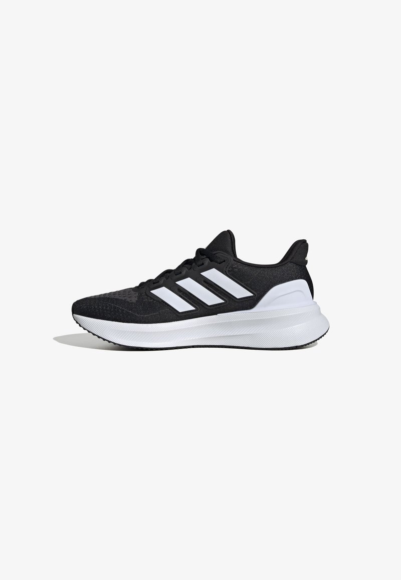 Chaussure de course noire et blanche avec trois bandes blanches sur le côté et une semelle blanche épaisse, vue du côté intérieur sur fond blanc.