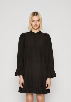 Black cotton dress with long, puffed sleeves, a ruffled neckline, button closure, and a flared hem featuring ruffle accents.