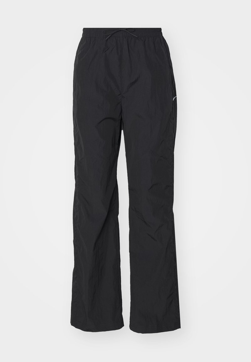Pantalons noirs légers avec une taille élastique et un cordon de serrage. Présentent une finition texturée et un petit logo réfléchissant sur le côté.