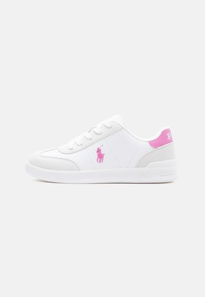 White low-top sneaker with pink logo and heel tab, lace-up design, and embossed sole branding on a plain light background.