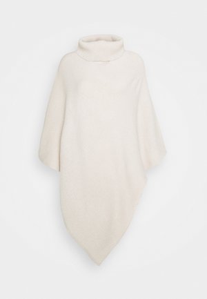 Light beige poncho with a high neckline, loose fit, and a textured knit pattern. Features a diagonal hem, offering a cozy and casual design.