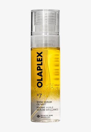 Botella transparente con aceite amarillo y líquido transparente separados, etiquetada como Olaplex No. 7 Shine Serum Oil Mist con tecnología patentada de enlace.