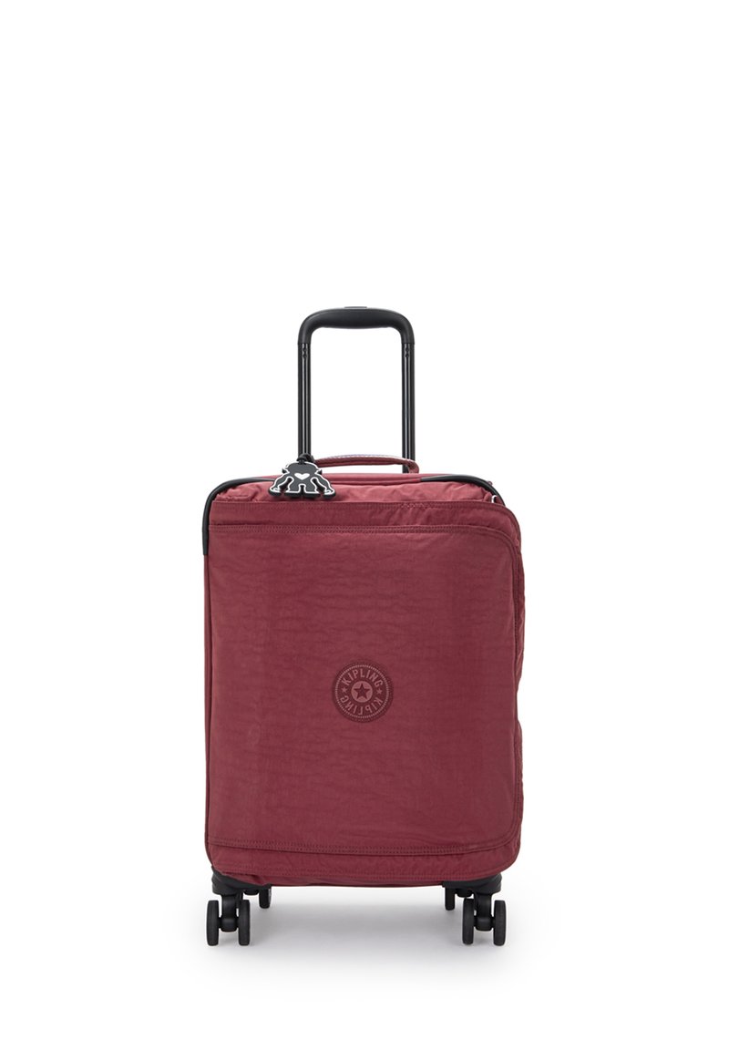 Red nylon spinner suitcase with a textured finish, black handle and wheels, featuring a circular logo on the front and zipper closure.