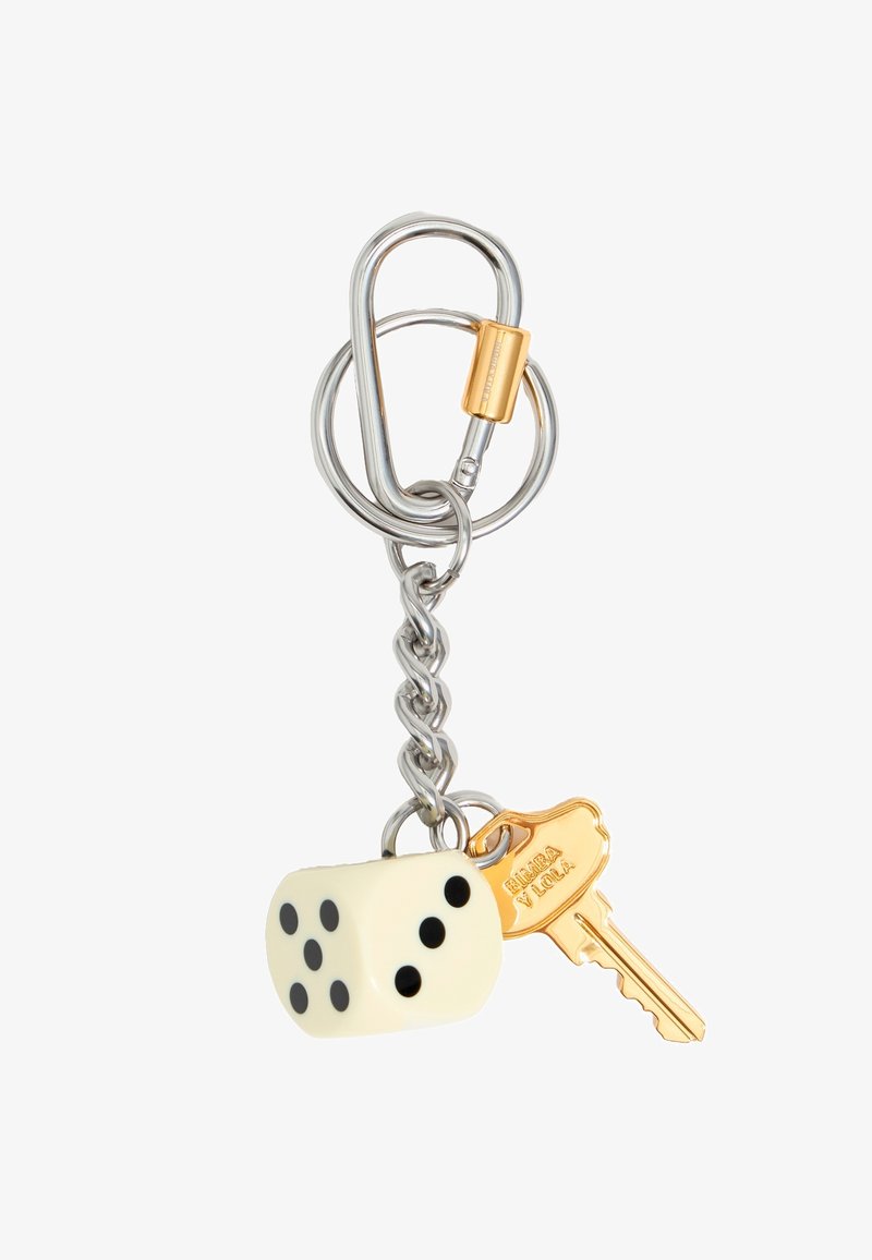 Ključna veriga z metalno verigo, kremasto barvo kocke z črnimi pikami in zlatim ključem z vgraviranim logotipom.