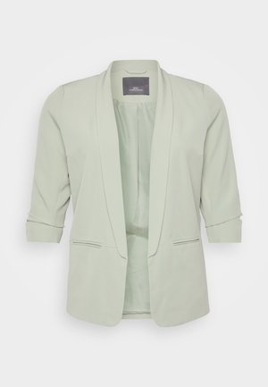 Lichtgroene blazer met een sjawl kraag. Hij heeft driekwartmouwen, twee zijzakken en een gladde, gestructureerde stof.