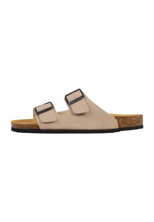 Sandale beige à enfiler avec deux brides réglables à boucle, semelle intérieure en liège et semelle noire, présentée de profil sur fond blanc.