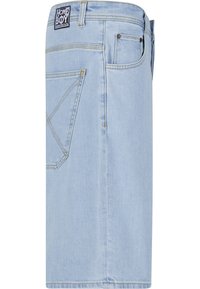 Fustă din denim albastru deschis cu buzunar la spate, bride pentru curea, cusături galbene și etichetă dreptunghiulară Homeboy Loud Couture deasupra buzunarului.