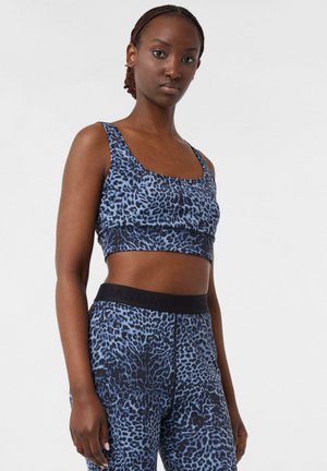 Top corto con stampa leopardata blu e leggings coordinati in un materiale liscio e elastico con vita nera, caratterizzati da un design aderente e dettagli senza cuciture.