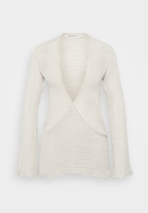 White knitted long-sleeve wrap sweater with deep V-neck and slightly frayed edges at cuffs and hem.