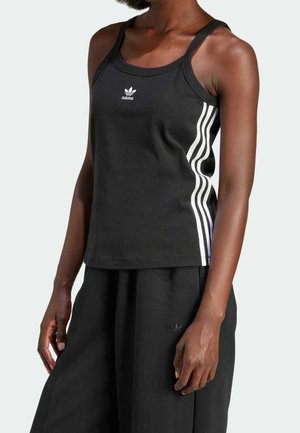 Black sleeveless Adidas tank top with white three stripes on sides, worn by a person with dark skin, paired with black pants.