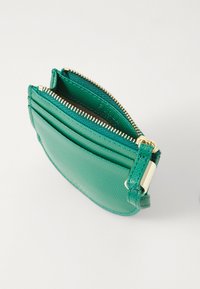 Green leather card holder with two zip compartments, textured finish, gold-toned hardware, and multiple card slots on one side.