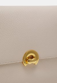 Coccinelle BINXIE - Handbag - white