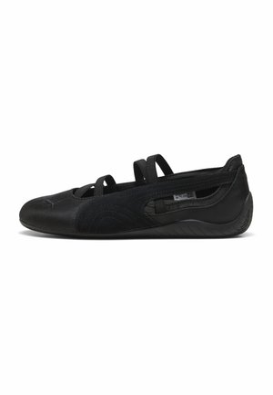 Black women's ballet flat with three elastic straps, suede and leather upper, and textured rubber sole, shown in side profile.