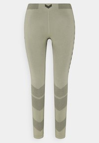 Ljust olivgröna leggings i stretchigt material, med en texturerad midjeband och ett chevronmönster på de nedre benen.