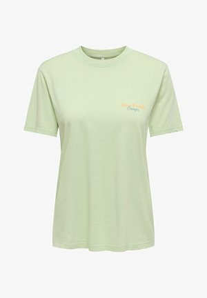 Light green short-sleeve crew neck T-shirt with small "Stay Fresh Oranges" text in orange and blue on the left chest.