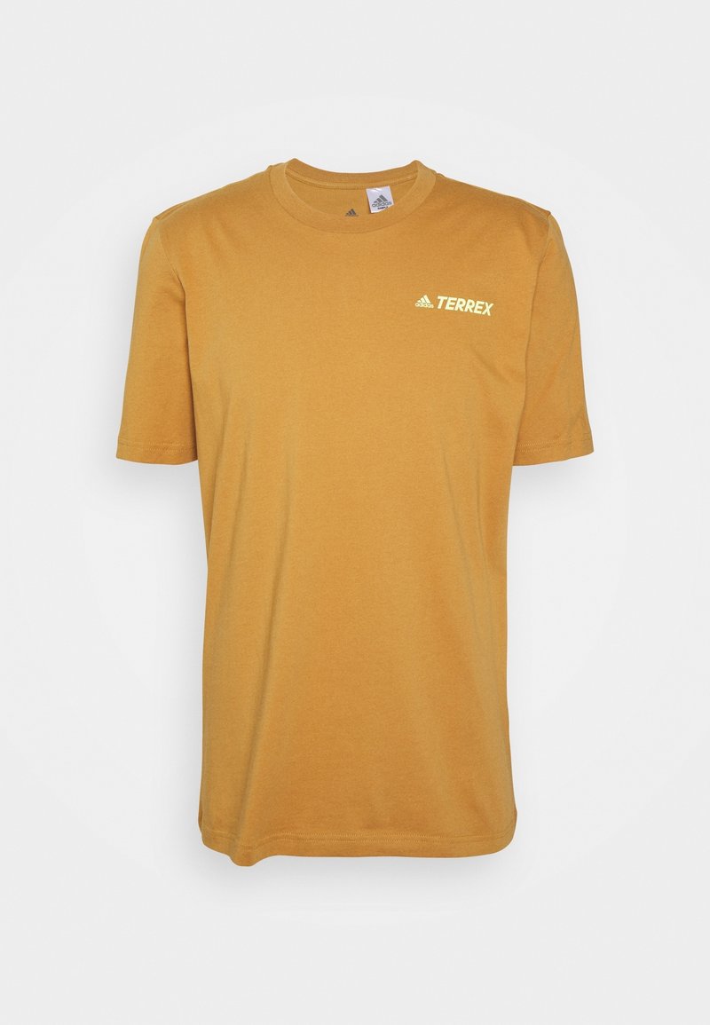 Geel katoenen T-shirt met een ronde hals, korte mouwen en een klein wit "Terrex" logo op de linker bovenborst. Zachte textuur.