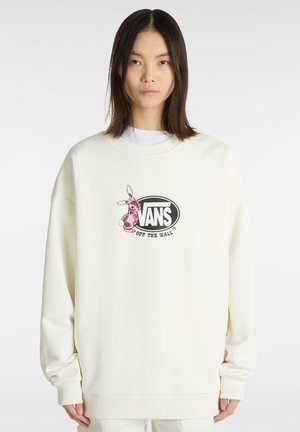 Licht crèmekleurig oversized sweatshirt met geribbelde manchetten, met een zwart ovaal logo met een roze konijnenillustratie in het midden.