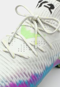 White football boot featuring a textured upper, neon green accents, and a gradient of pink and blue on the sole. Laces are gray with yellow detailing.