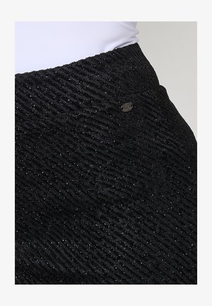 Black textured skirt featuring a wavy pattern, metallic thread accents, and a small metal logo detail at the waistband.