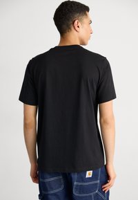 Black cotton t-shirt with short sleeves and a relaxed fit, featuring a classic crew neck and a smooth texture, displayed from the back.
